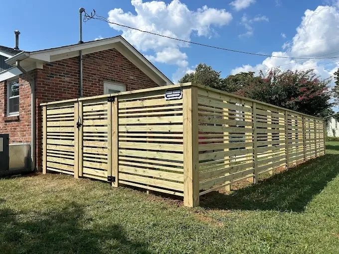 Weathered wood fence section with a leaning post